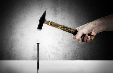 Hand with hammer nailing
