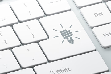Business concept: Energy Saving Lamp on computer keyboard backgr