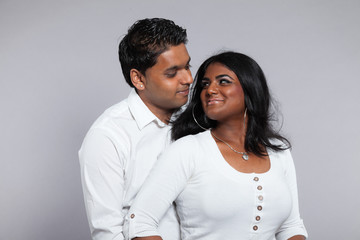 Young romantic indian couple. Wearing white shirt and jeans. Stu