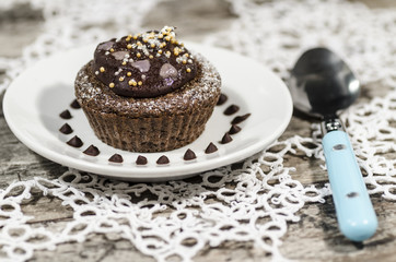 Diet chocolate cupcakes on white plate with pink spoon
