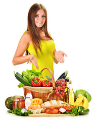 Young woman with assorted grocery products isolated on white