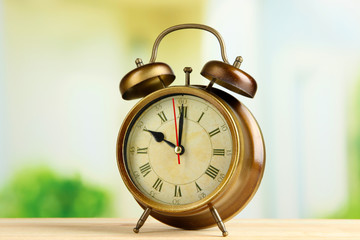 Old alarm clock  on bright background