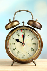 Old alarm clock  on bright background