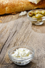 Bowl of cottage cheese on wooden table. Copy space