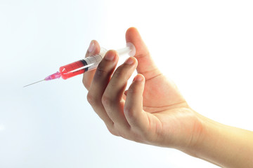Color photograph of medical syringes with blood