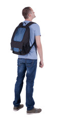 Fototapeta premium Back view of man with backpack looking up.