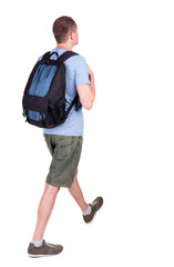 back view of walking  man  with backpack.