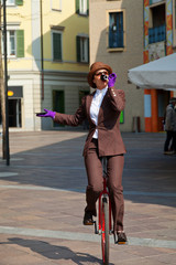 business woman drink a coffee on the unicycle © alexandre zveiger