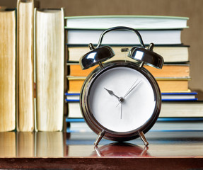 Alarm clock and books. Education concept