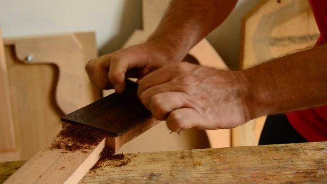 Luthier sanding a mastil guitar