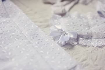 Obraz na płótnie Canvas beautiful white dress and bonnet for a newborn baby