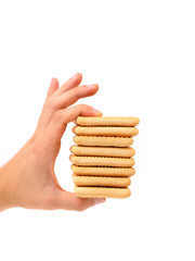 Hand holds stake saltine soda cracker.