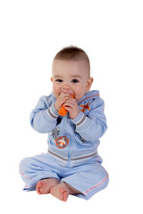 Smiling baby eats carrot