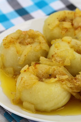 Potato dumplings with fried onions, close up