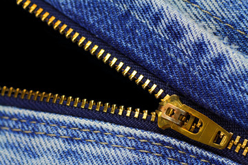 Open zipper of blue jeans  with black opening