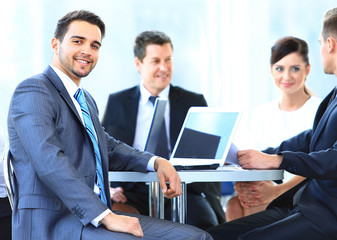 Fototapeta premium business man smiling during meeting with colleagues