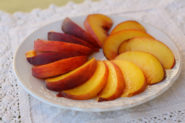 Sliced peach on lace doily