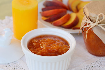 Homemade peach jam in white bowl