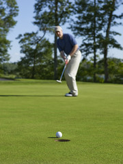 Golfer sinks putt on green