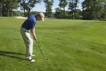 Golfer chipping onto green