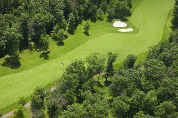 Aerial view of a golf course fairway with golfers - obrazy, fototapety, plakaty