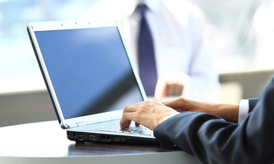 Person Typing on a modern laptop in an office