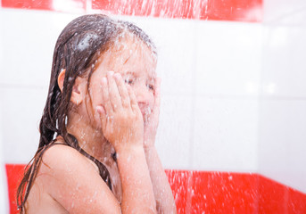 Fototapeta na wymiar Small pretty girl is taking a shower