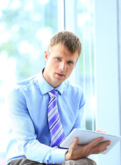 Portrait of a businessman working on his tablet