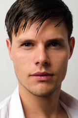 Fototapeta premium Portrait of a beautiful man posing fashion in a studio