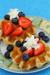 Belgian wafers with strawberries, blueberries and whipped cream