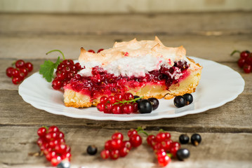 Piece of berry pie, red and black currants