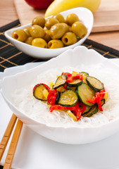 Rice noodles and vegetables on white plate