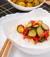 Rice noodles and vegetables on white plate