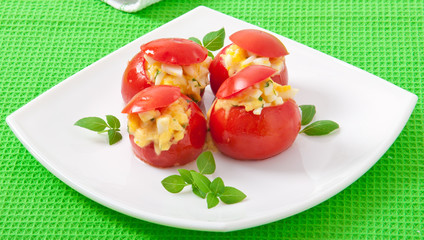 Tomatoes stuffed with cheese, egg with fresh herbs basil