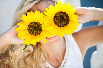 portrait of attractive woman with sunflowers in her hand