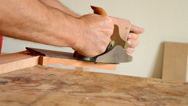 Luthier working with a wood planer in a mastil guitar
