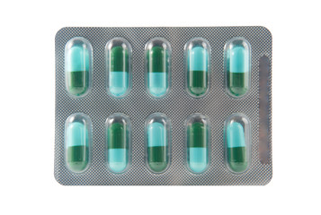 Green and blue capsule in blister pack on white background