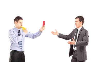 Guy showing a red card and blowing a whistle to a businessman