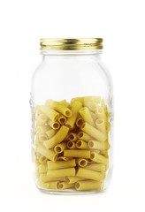 glass jar with pasta in a white background