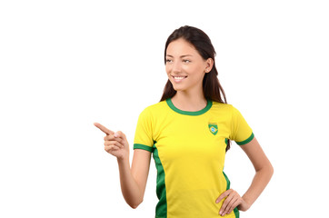 Girl with Brazilian flag on her shirt pointing in front.