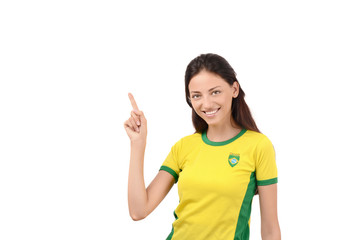 Girl with Brazilian flag on her shirt pointing up.