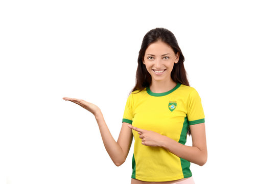 Girl with Brazilian flag on her shirt pointing and showing.
