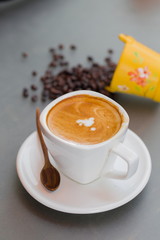 close up a cup of coffee on gray table