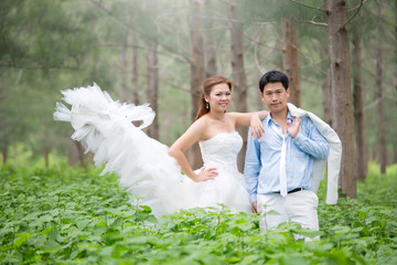 happy bride and groom  in the green forest