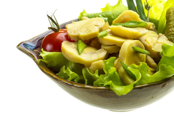 Marinated mushrooms in white saucer isolated on white