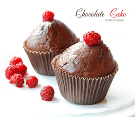 Chocolate fruitcakes covered with raspberry on white background