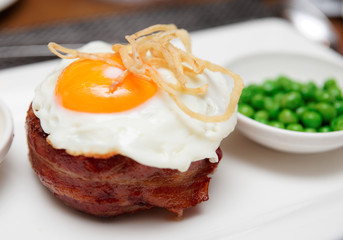 Tenderloin steak with fried egg and green pies, british dish