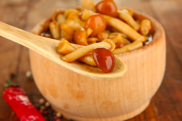 Mushrooms in bowl, on wooden background