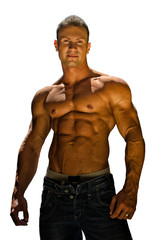 Handsome, muscular shirtless bodybuilder isolated on white