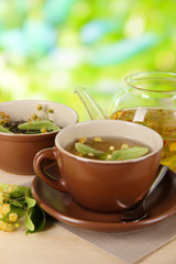 Kettle and cup of tea with linden